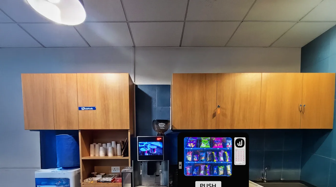 Modern compact card reader unit beside a sleek vending machine