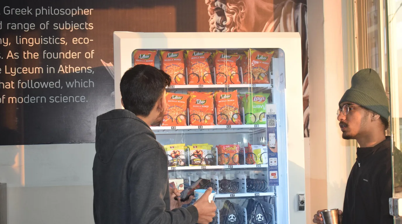 Still life of a book vending machine model with colour swatches and children's books