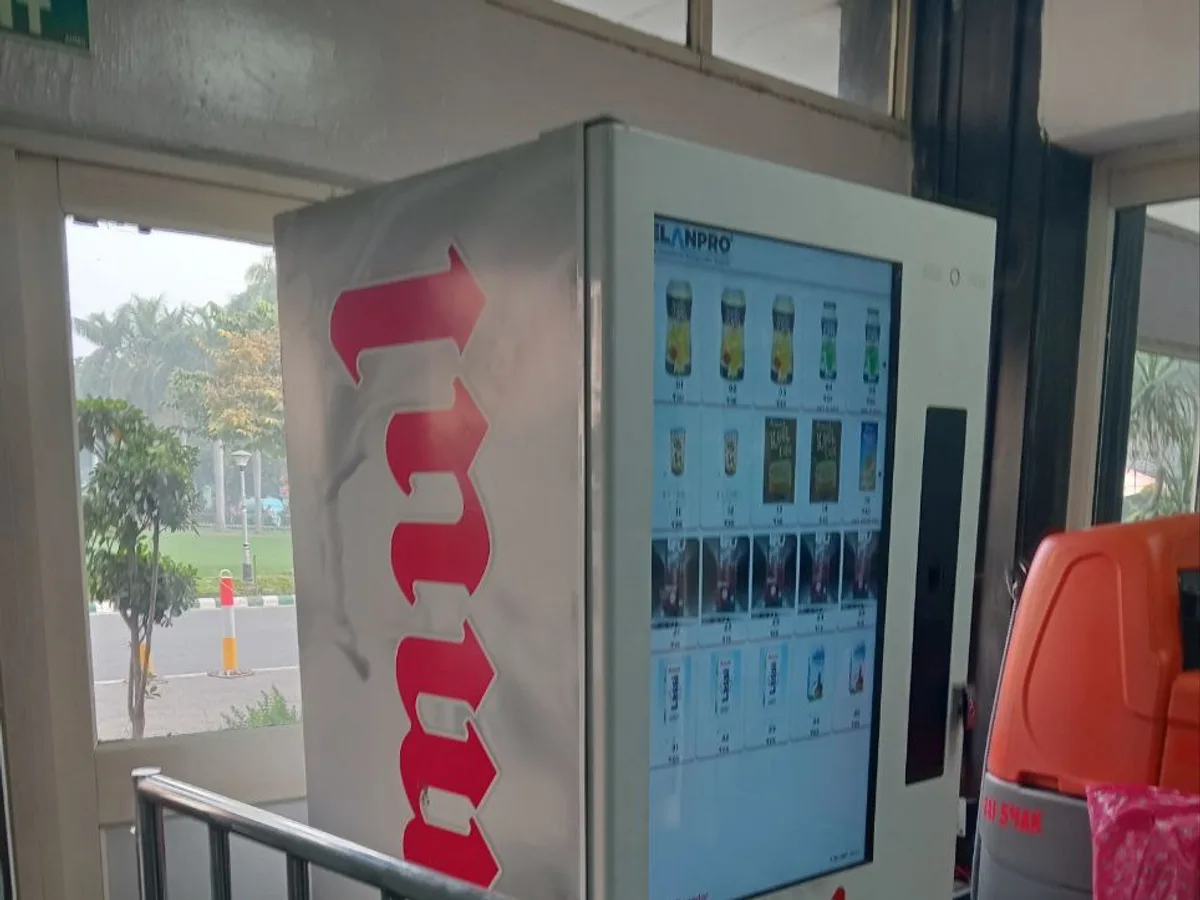 Customer happily selecting a chocolate bar from a modern chocolate vending machine