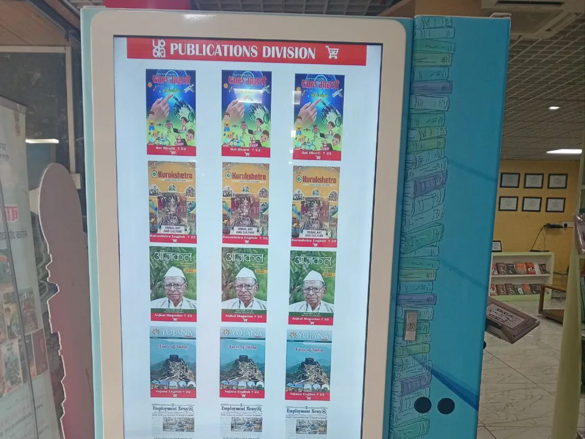 Operator viewing a real-time vending dashboard with a connected machine in the background