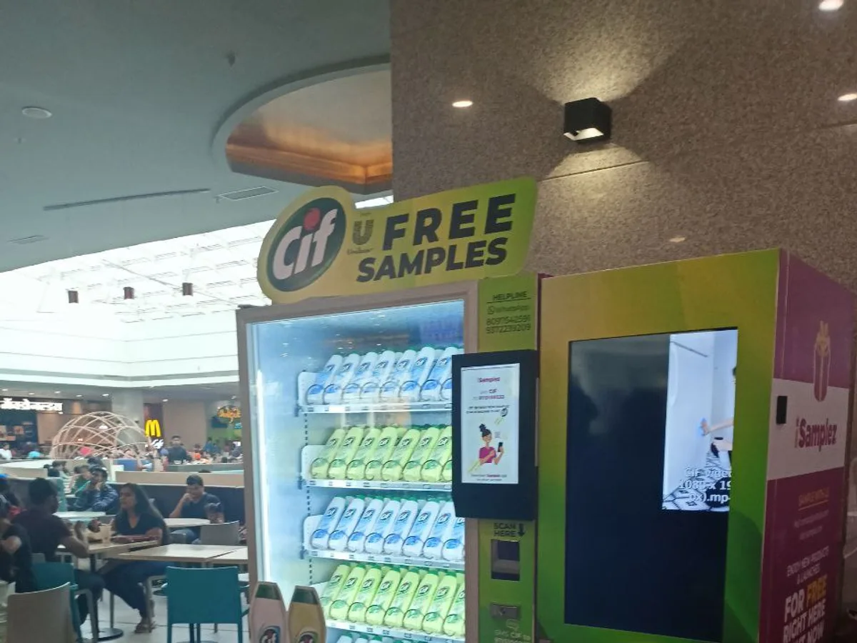 A wrapped standard vending machine beside a bespoke fully custom-built machine