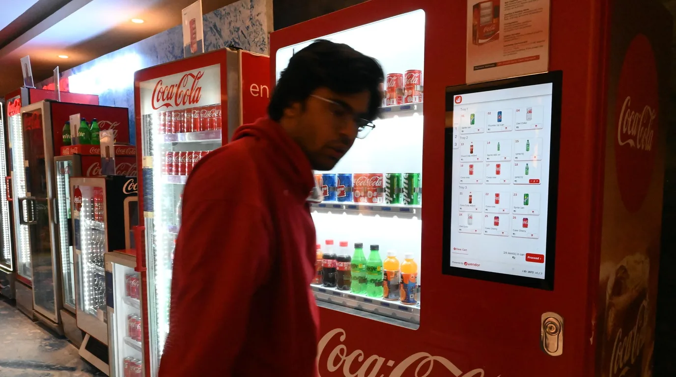 Entrepreneur filling out a vending machine permit application on a laptop at a desk