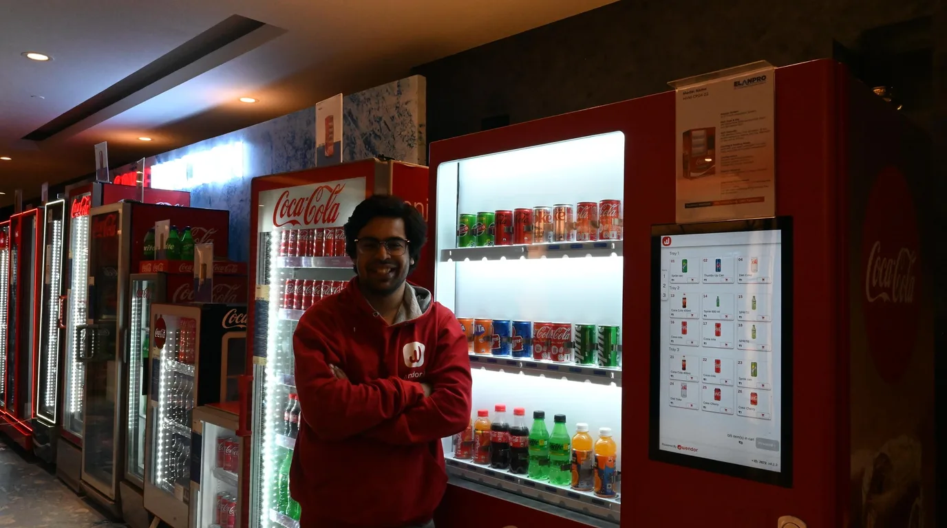 Fresh salad jar in the lit delivery bay of a refrigerated vending machine