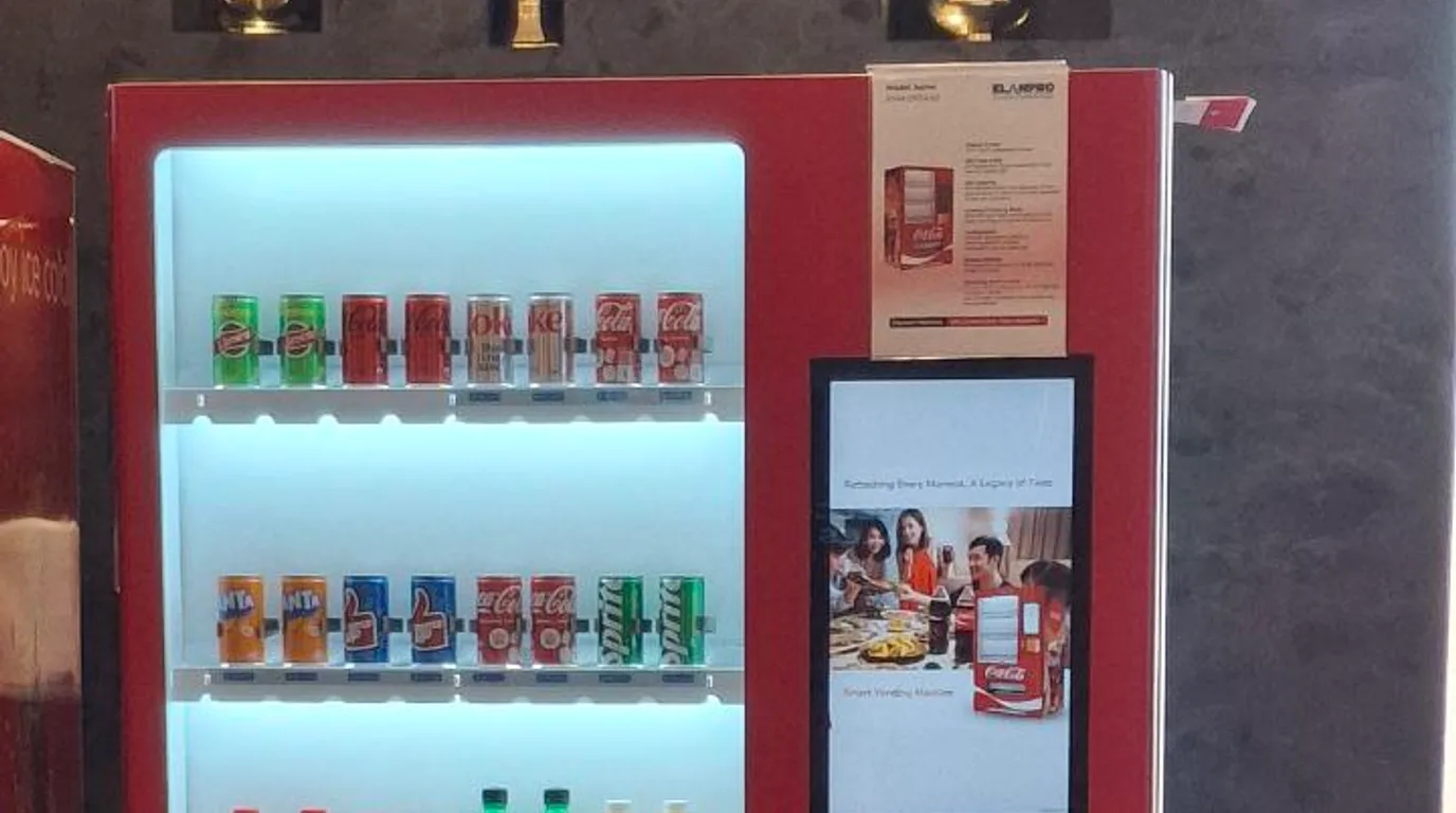 Several snacks and drinks dispensing together from a modern vending machine