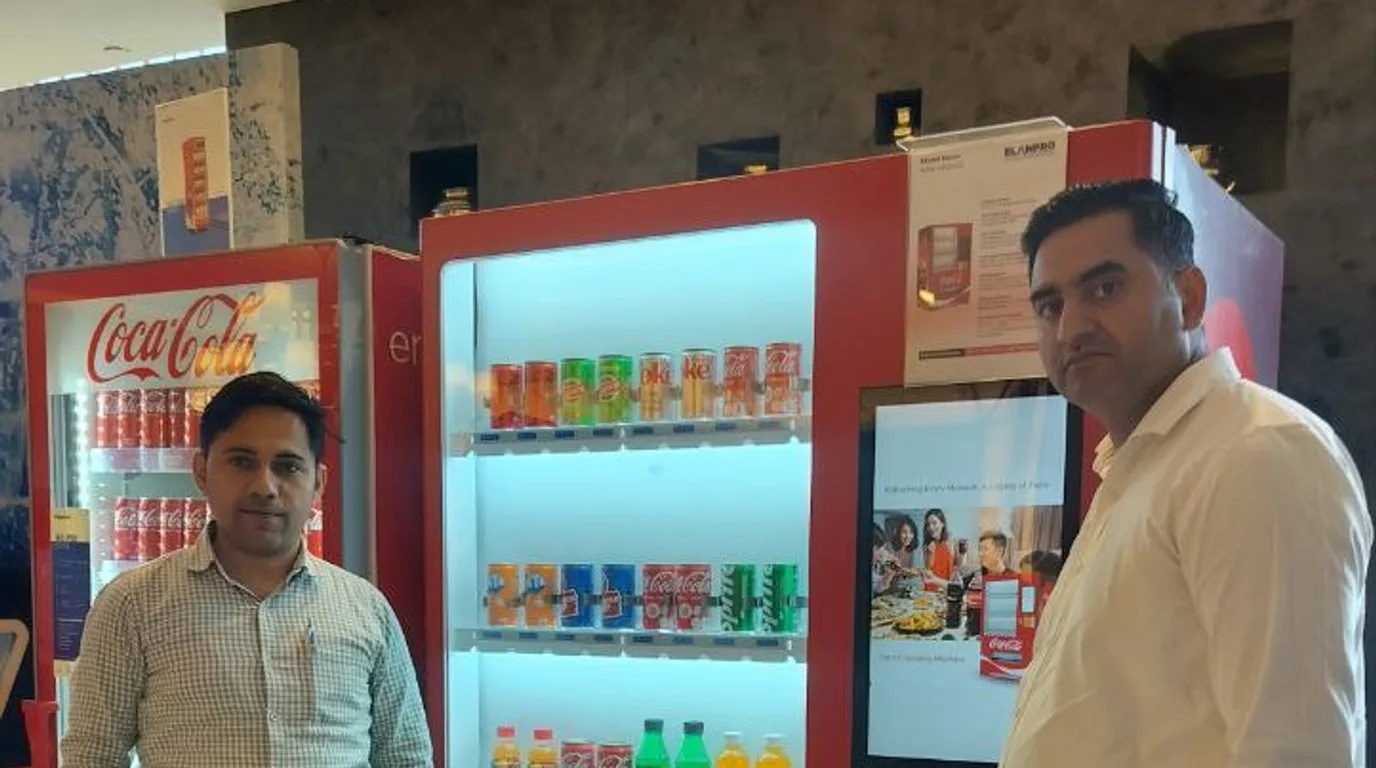 Customer viewing an instant refund notification beside a modern vending machine