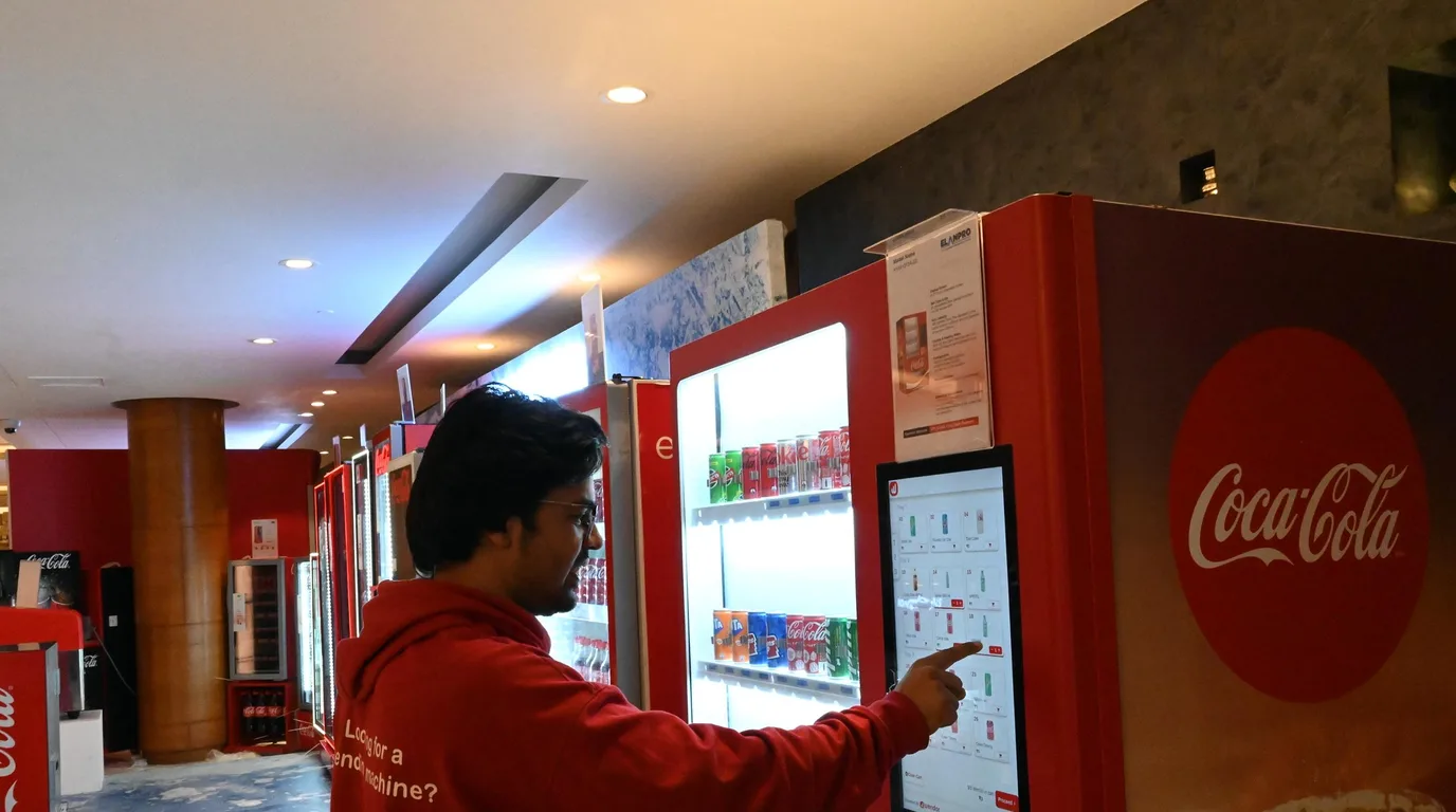 Automated robotic lift moving a car inside a glass vending tower