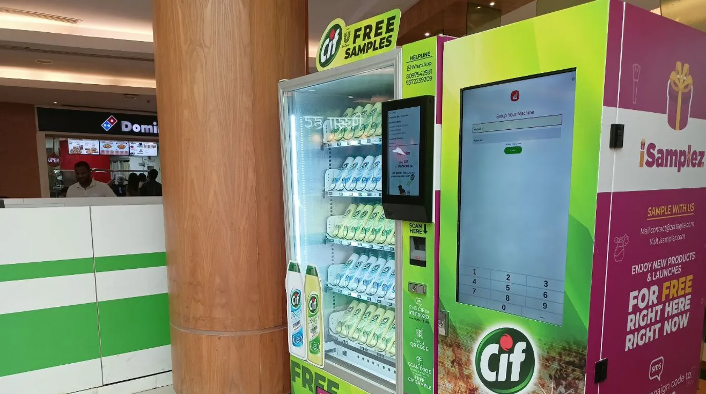 Person dangerously rocking a vending machine by its top corners, shown as a hazard