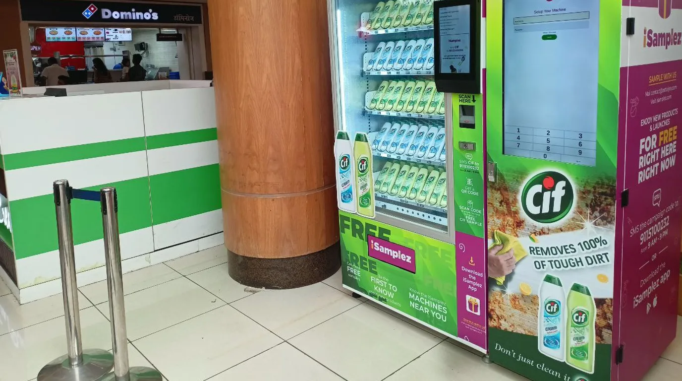 Customer scanning a support QR code on a vending machine instead of shaking it