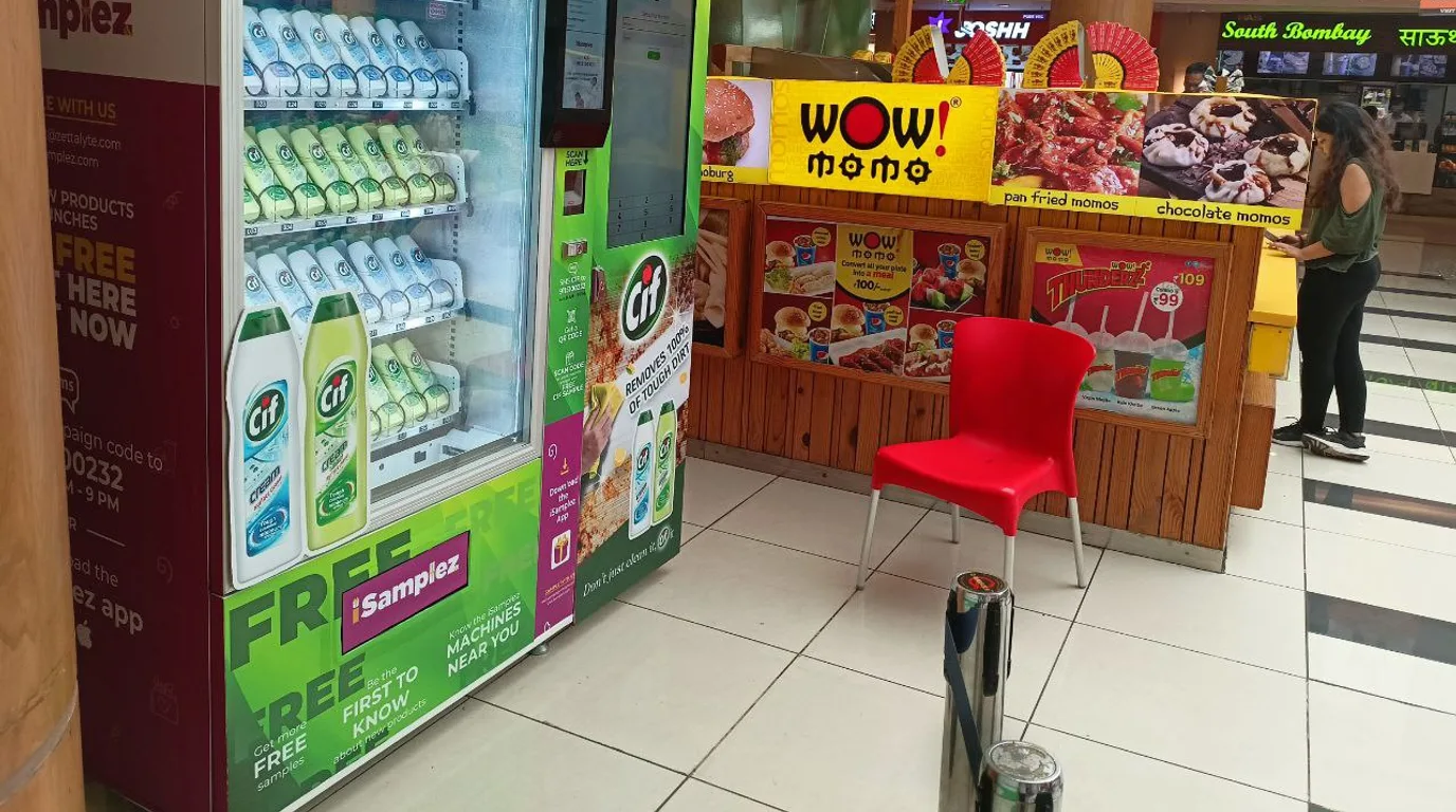 Same vending machine compared in a quiet hallway versus a busy concourse