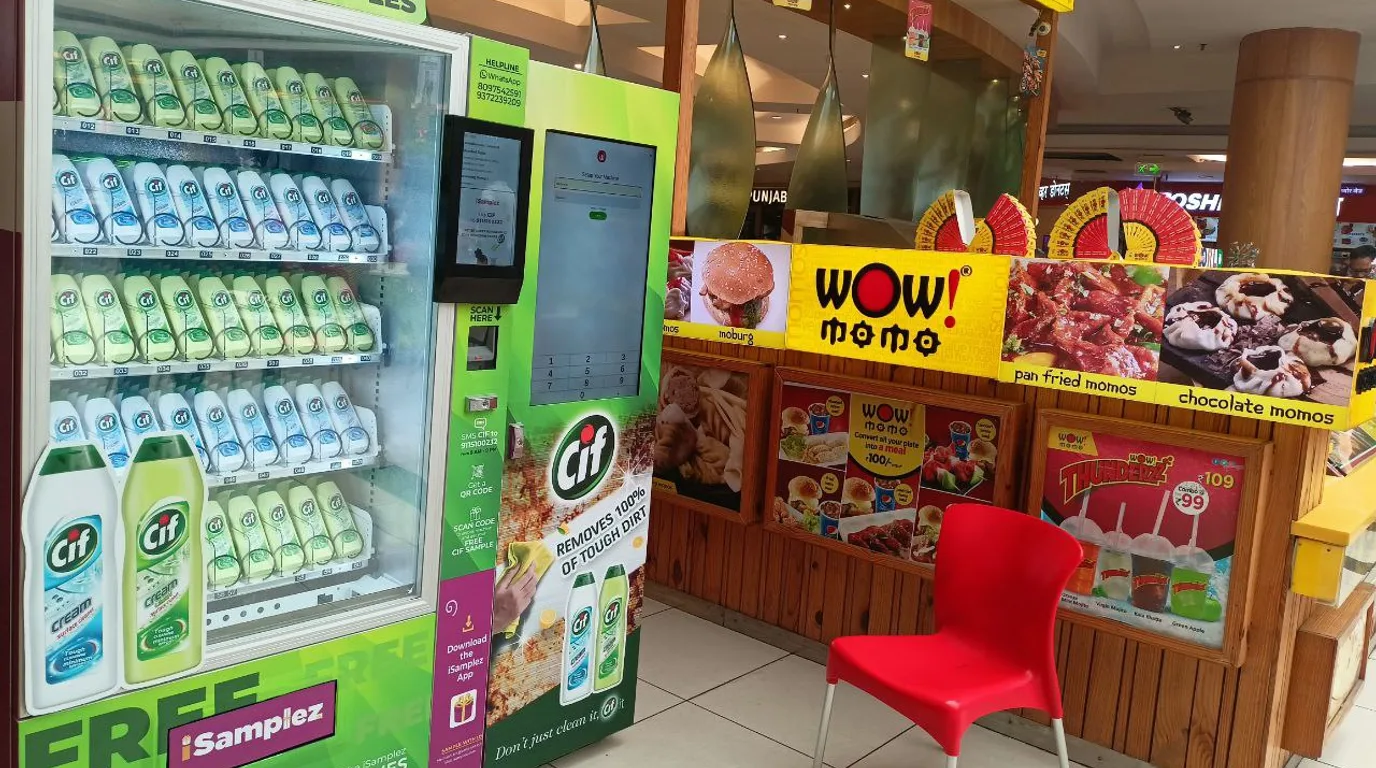 Overhead flat-lay of vending cost factors around a model machine