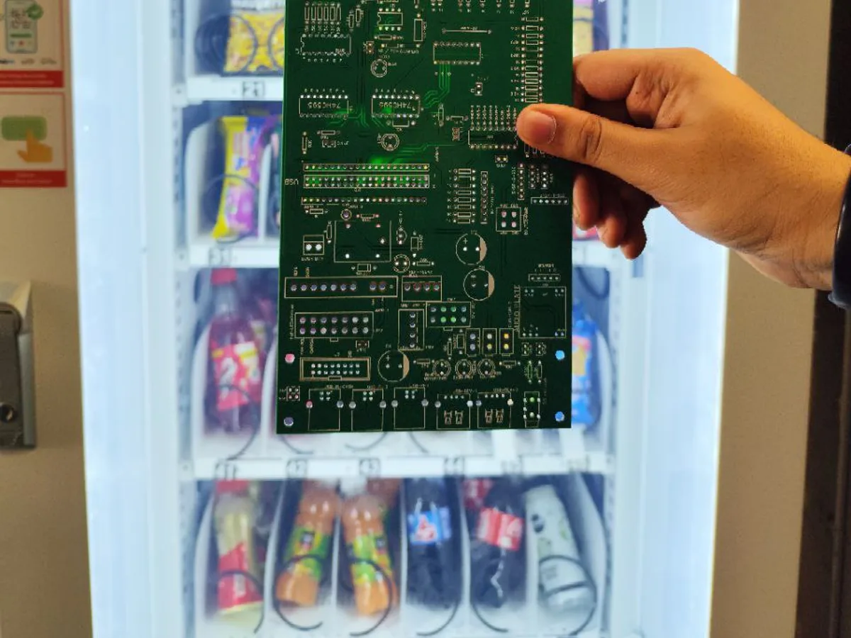 Close-up of a vending machine MDB control board connector next to a cashless payment reader.