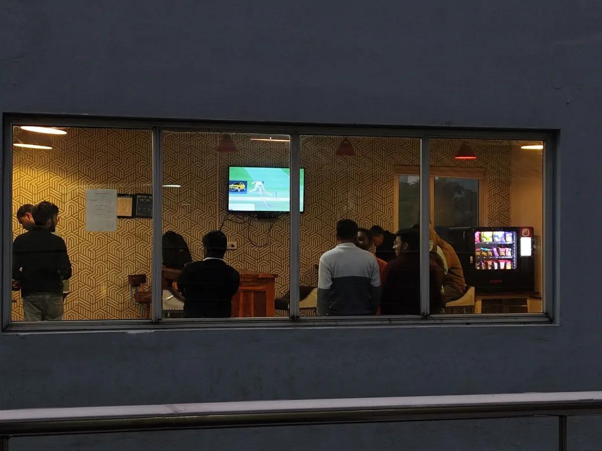 Person mapping target vending locations with pins on a digital city map at a desk.