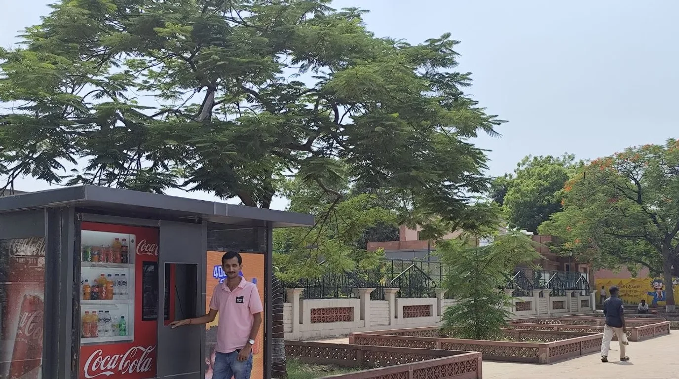 Satisfied customer collecting a product from a clean well-stocked vending machine.