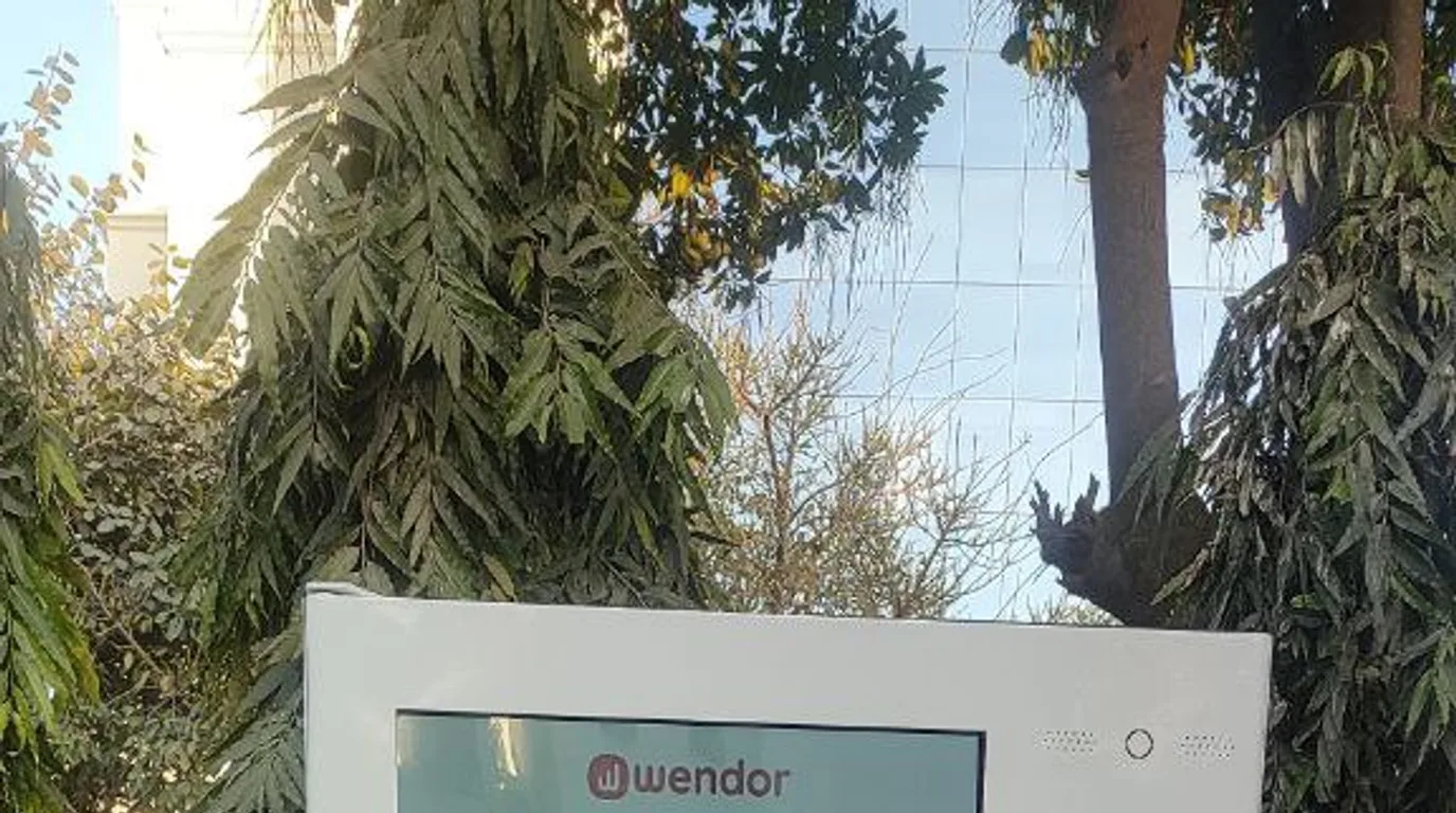 Operator remotely monitoring connected vending machines via a mobile management app.