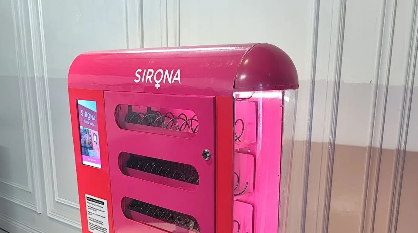 Close-up of a vending machine contactless payment panel with a smartphone