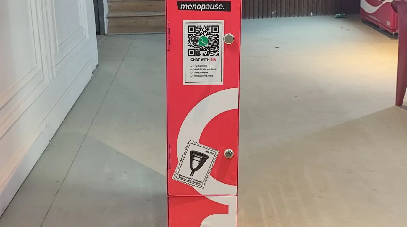 Technician inspecting vending machine refrigeration and wiring for a fault