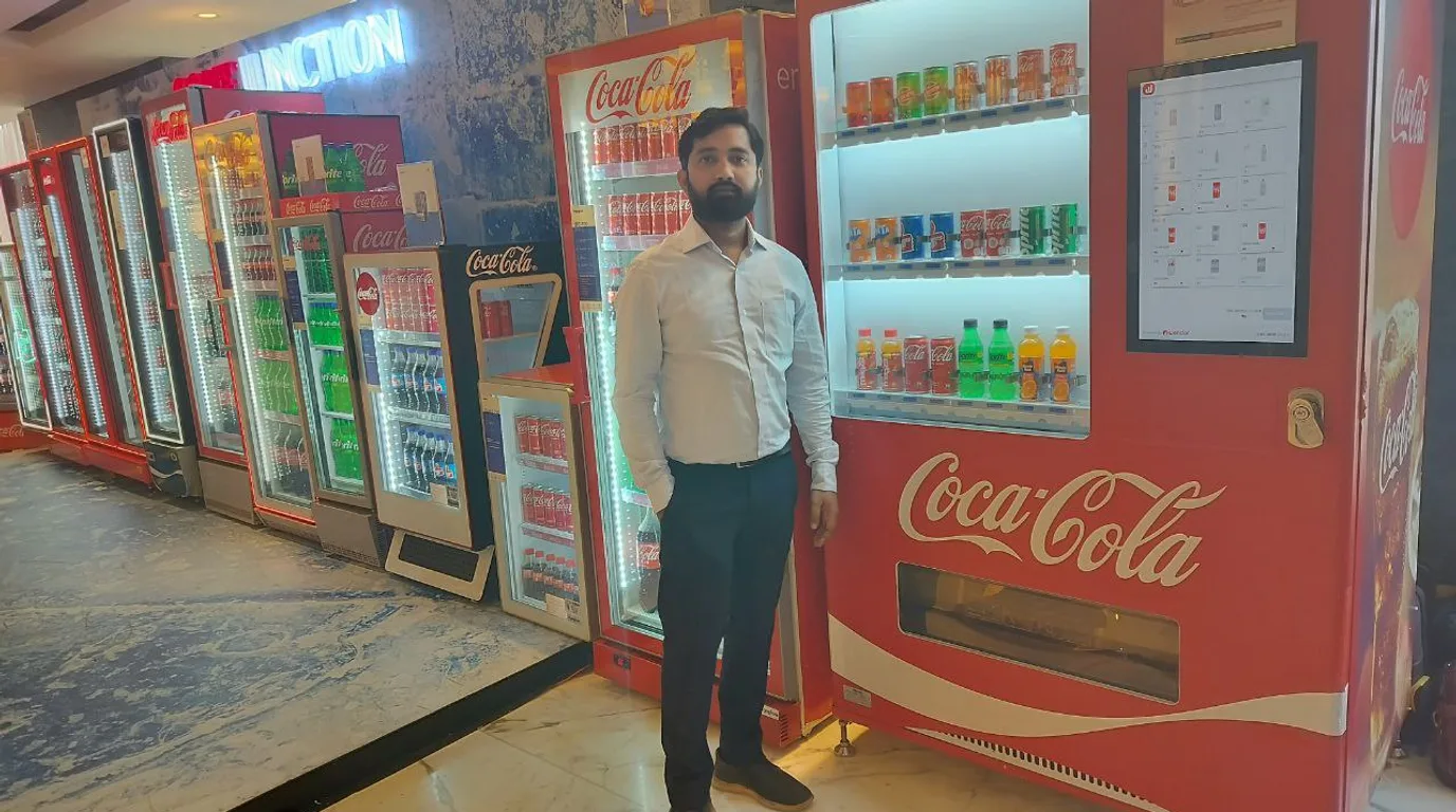 Well-stocked vending machine shelves with Indian snacks and drinks