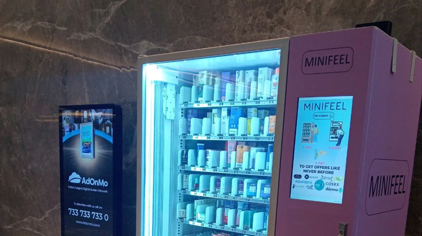 Operator before a row of leased vending machines at a corporate campus