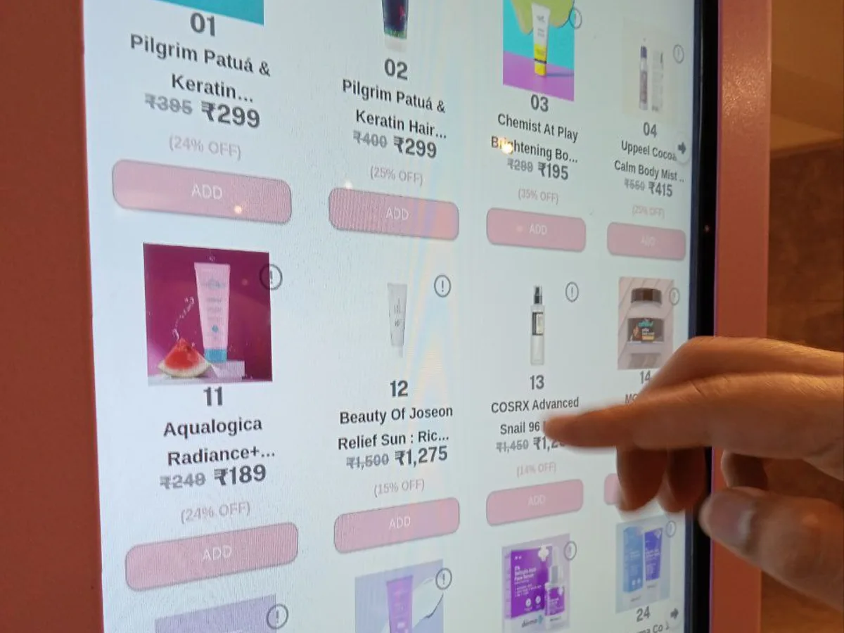 Health worker restocking a harm-reduction vending machine using a tablet