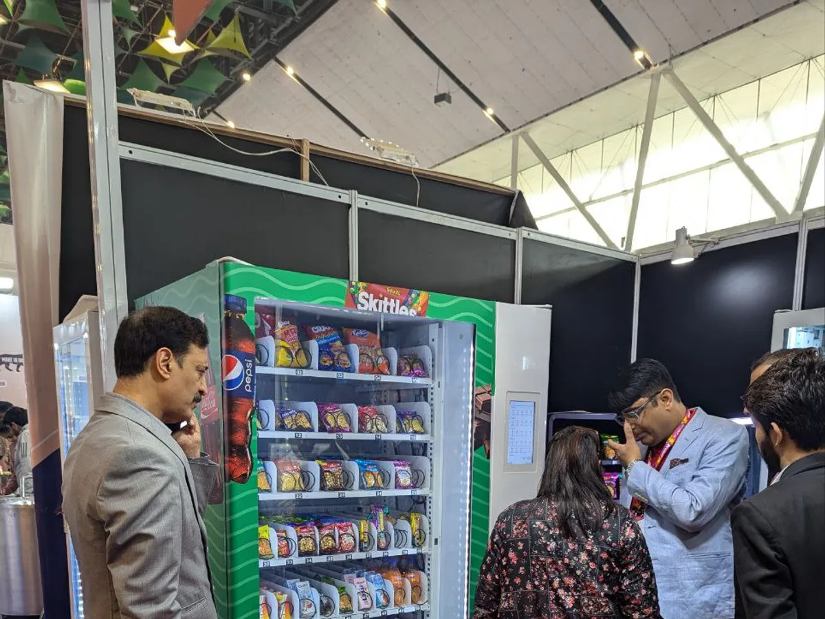 Fresh pizza beside a calculator and sales tablet illustrating vending profit margins