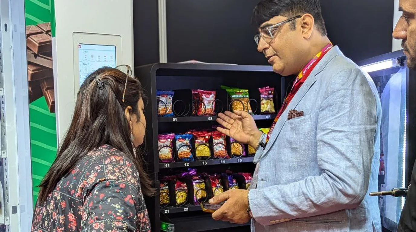 Hands reviewing bank statements and a sales dashboard to verify vending income
