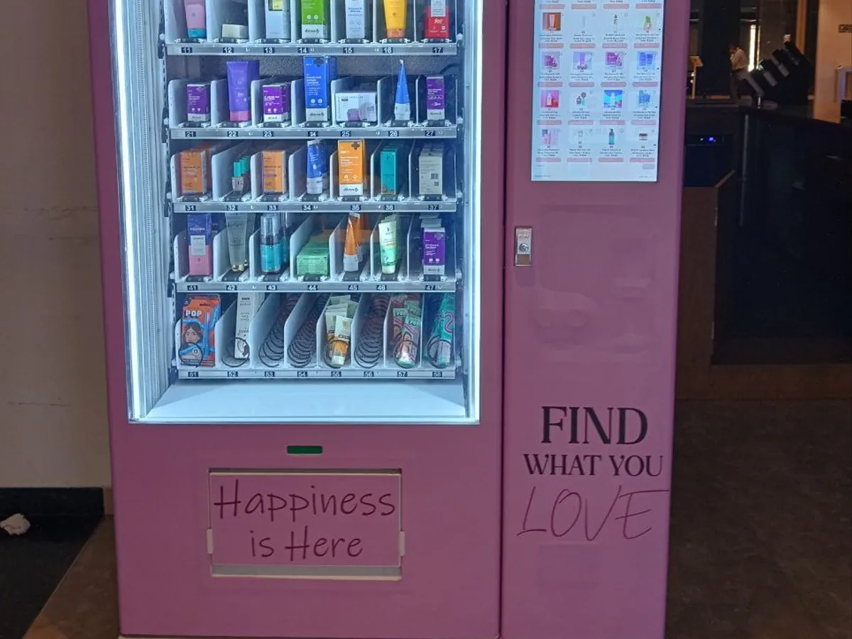 Reverse vending machine scanning a bottle barcode with sorting bins visible
