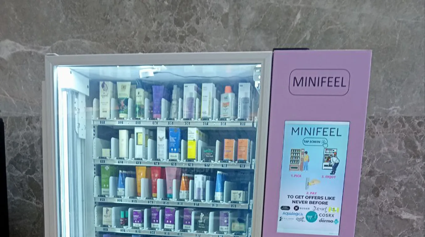Shoppers recycling containers at a reverse vending machine and receiving rewards