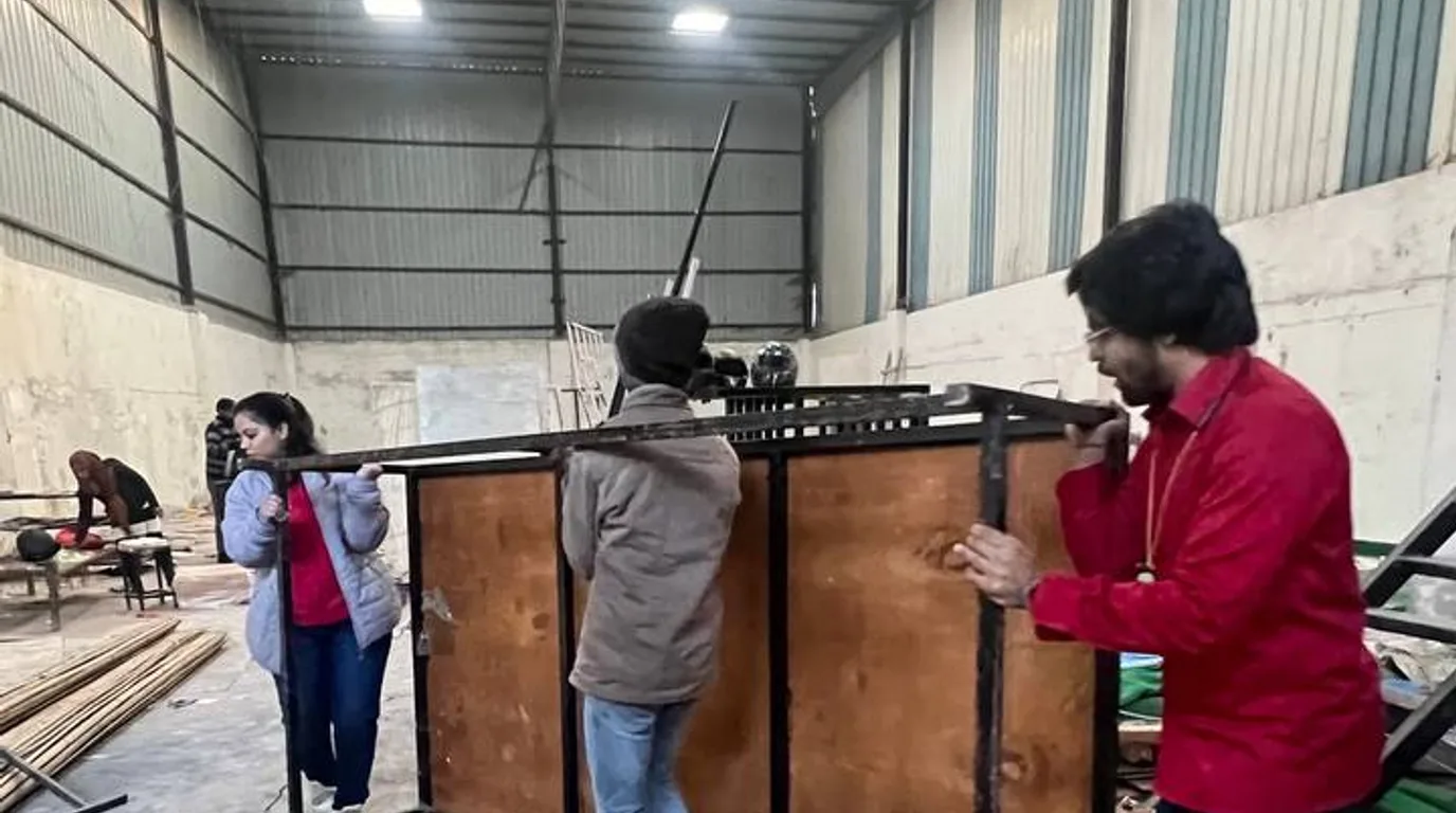 Buyer inspecting refrigerated drink machines in a dealer warehouse