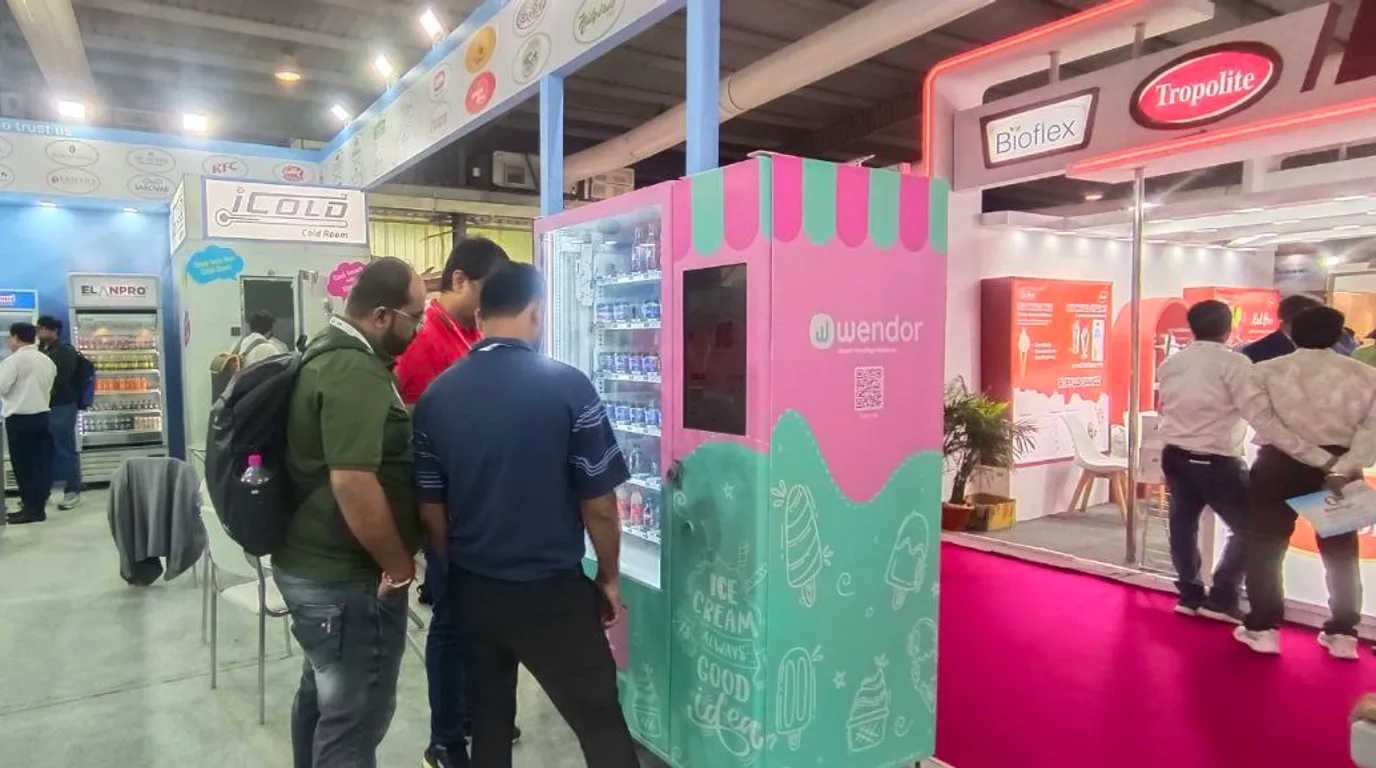 Deep-freeze vending machine dispensing a colorful cup of bead ice cream at a family venue