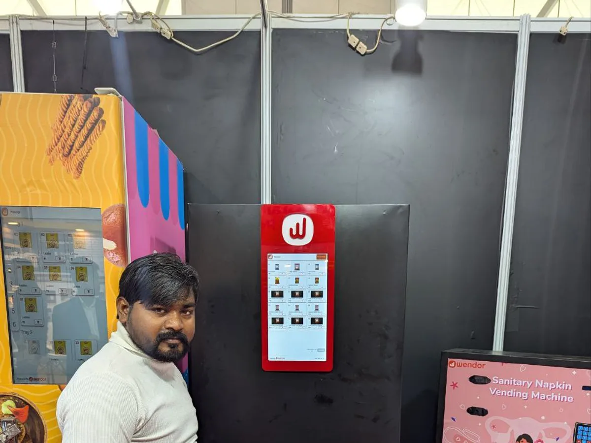 Refrigerated egg vending machine dispensing a carton of fresh eggs