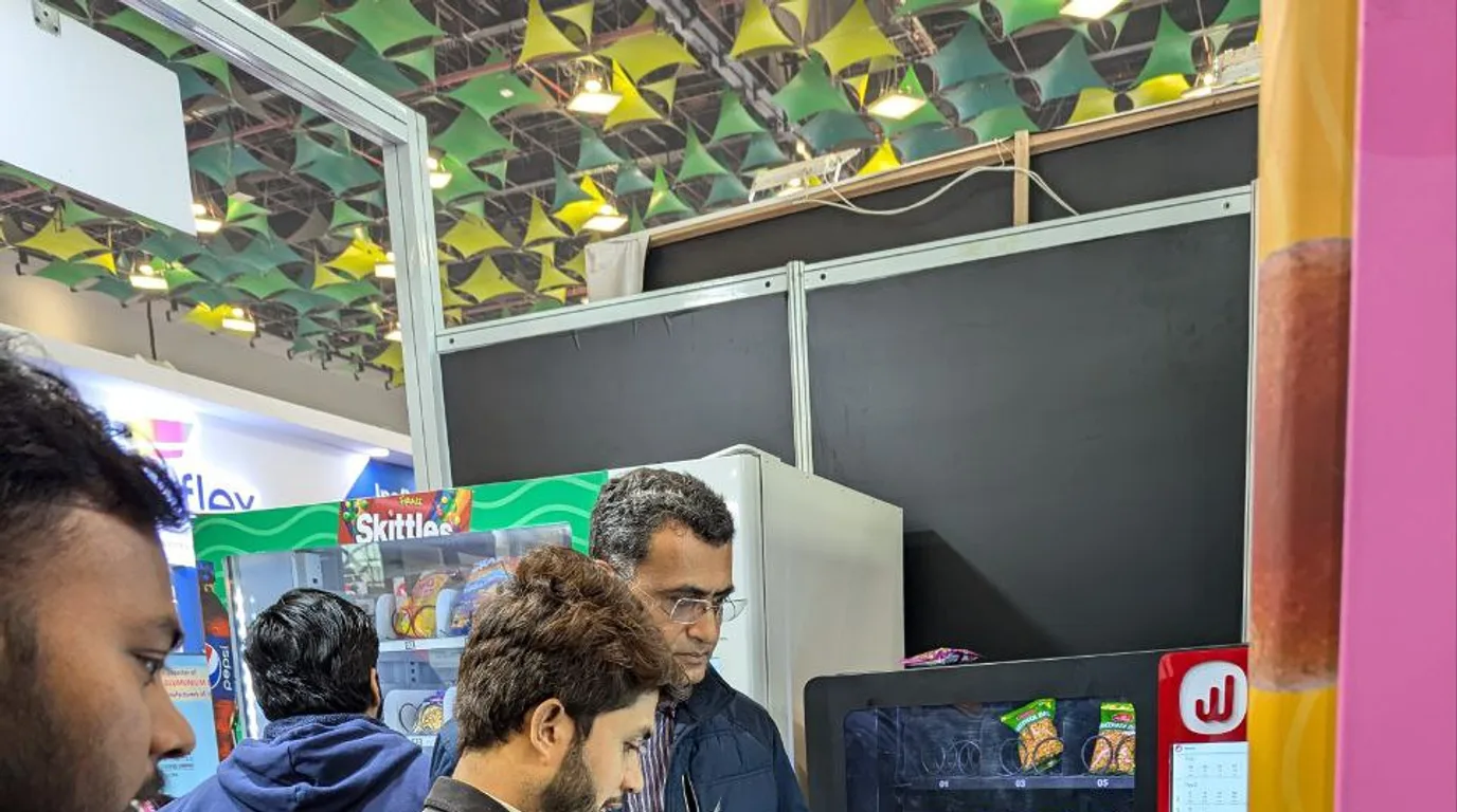 Smartphone scanning a vending machine QR code to complete a UPI payment