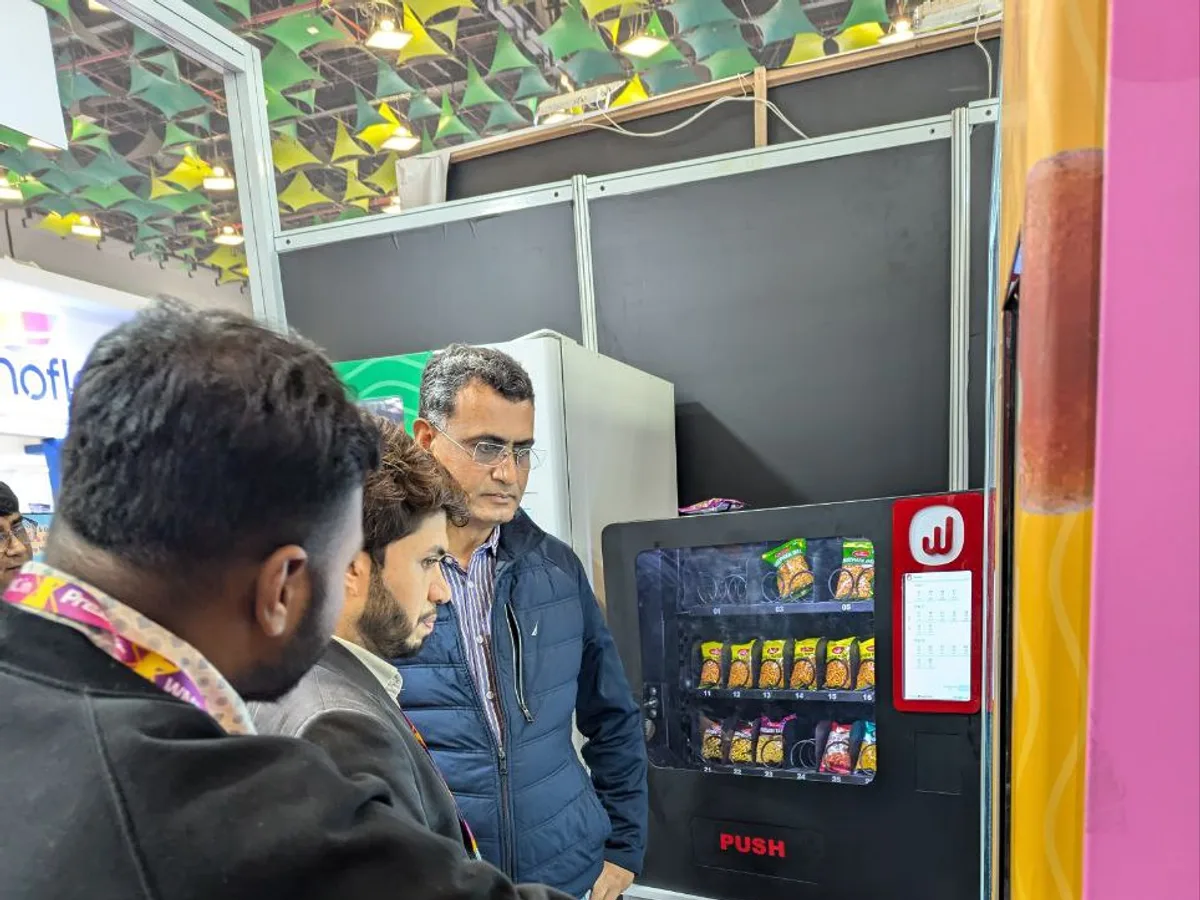 Hand selecting an item on a vending machine keypad or touchscreen