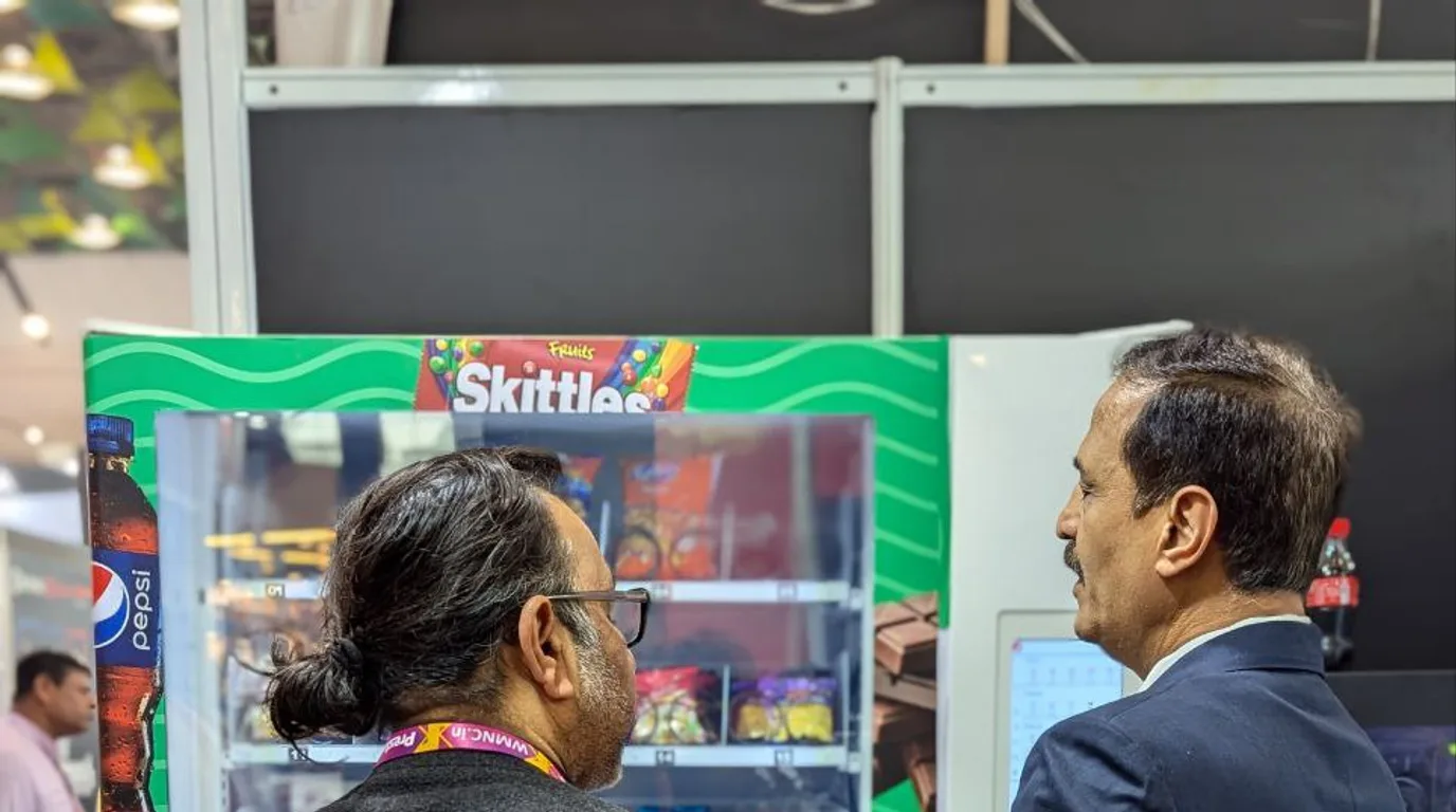 Person calmly calling a vending operator to request a refund