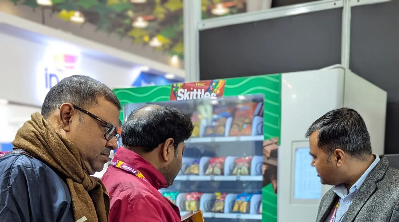 Health inspector reviewing a clean refrigerated vending machine in California