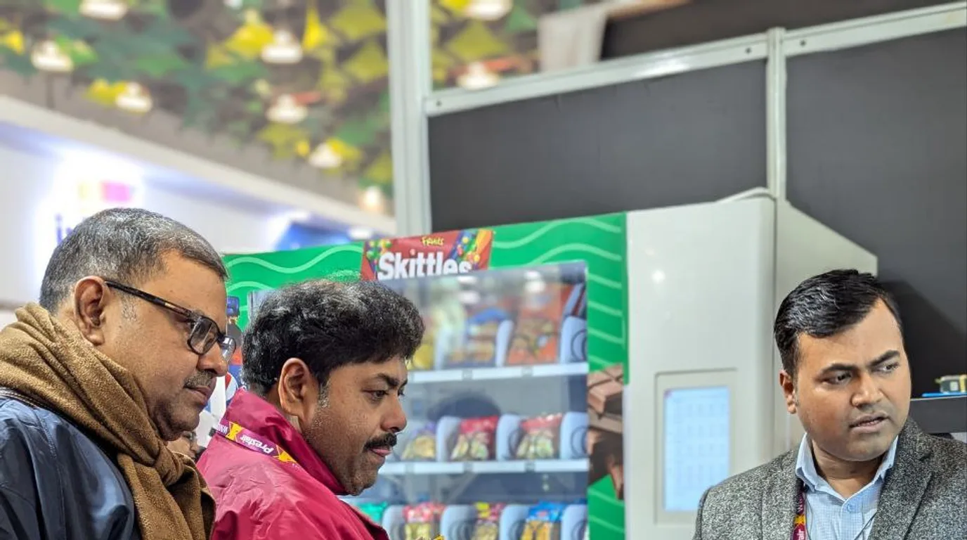 Tapping a phone to pay contactlessly at a modern vending machine