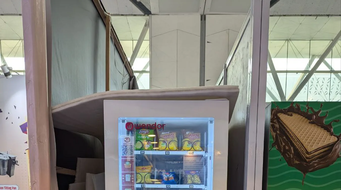Inspector reviewing a clean refrigerated vending machine in Georgia