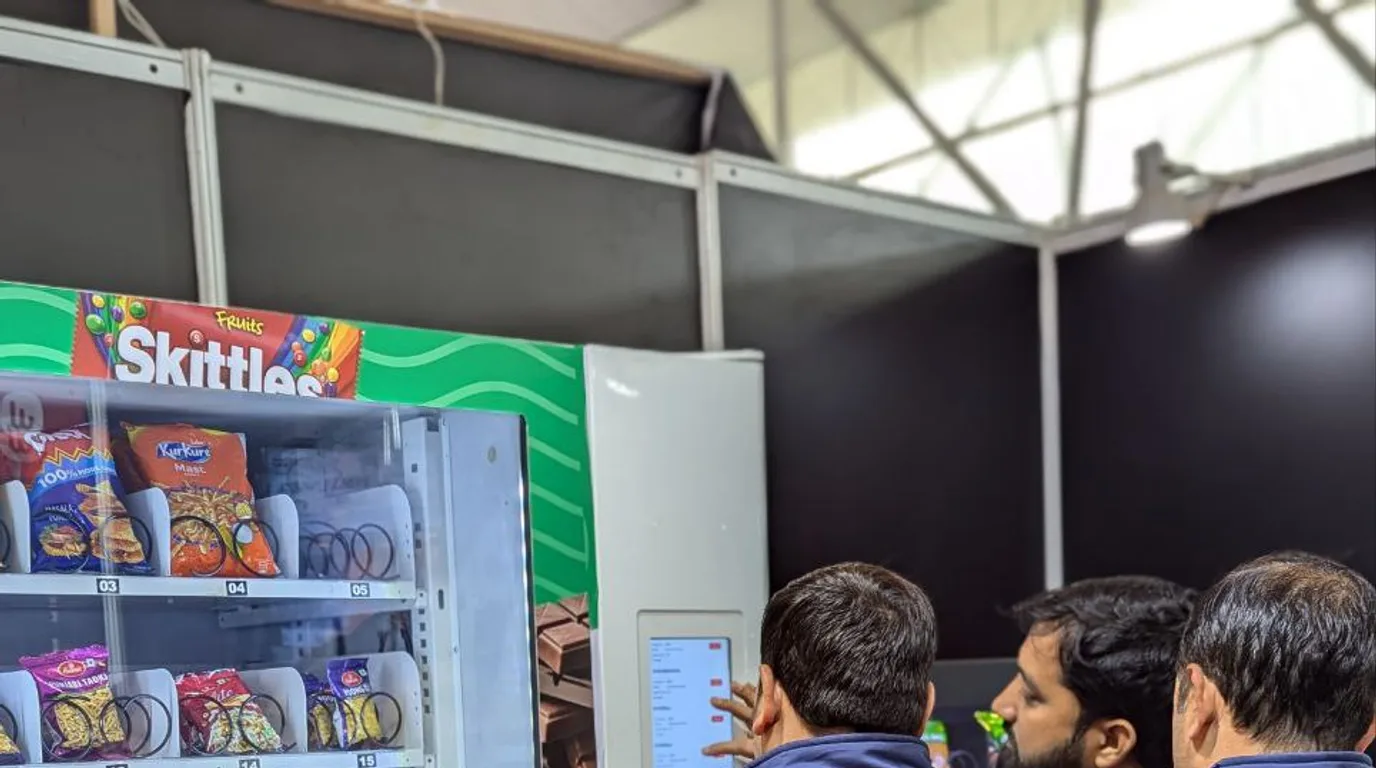 Tapping a phone to pay contactlessly at a modern vending machine in Georgia