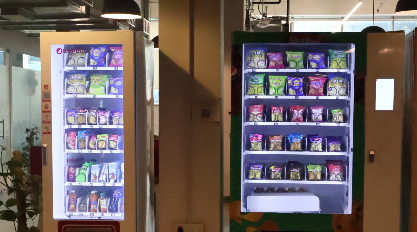 Overhead flat-lay with an Ohio vendor's license, calculator, and vending machine model