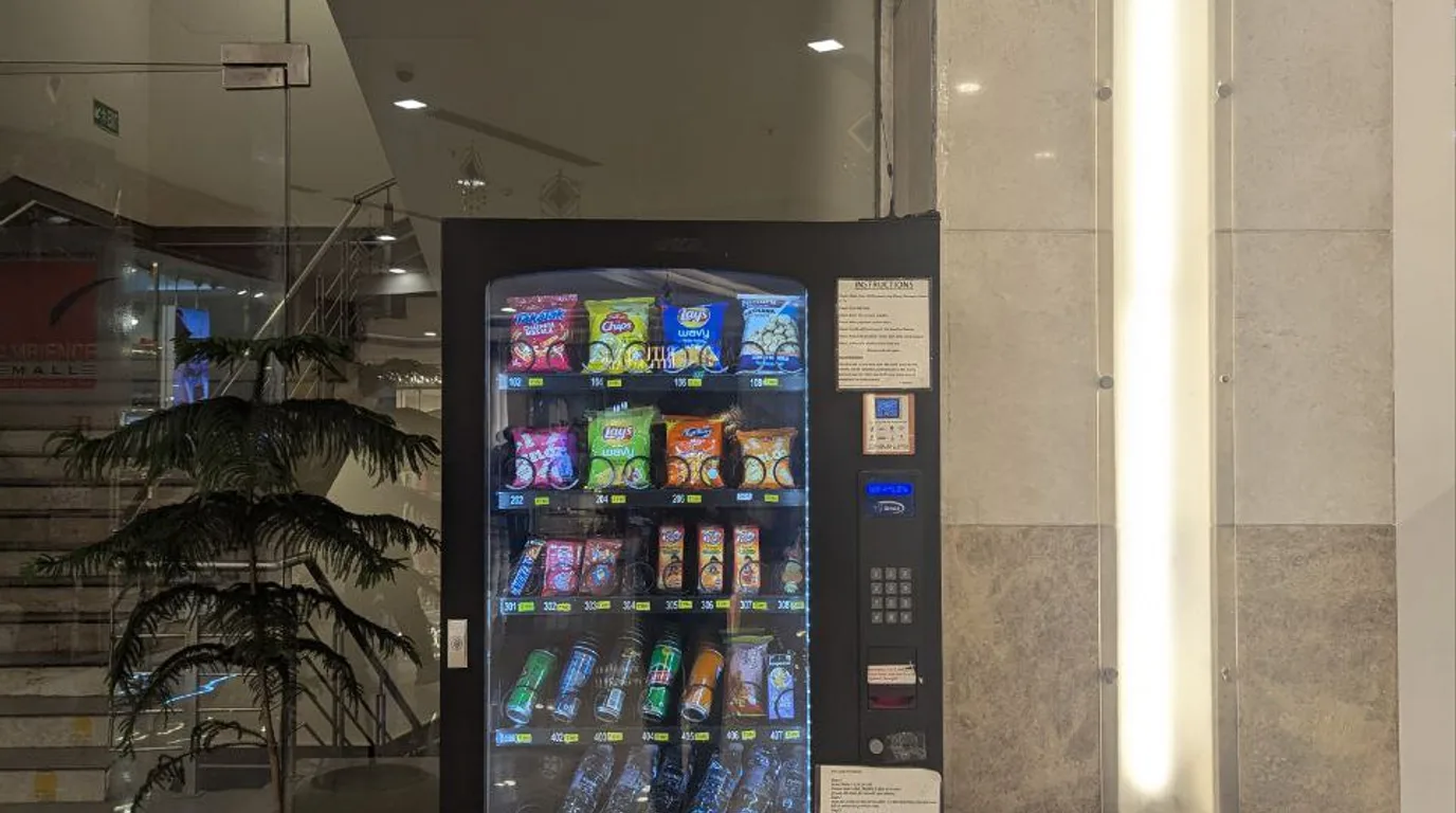 Modern vending machine in a busy Texas office park with workers