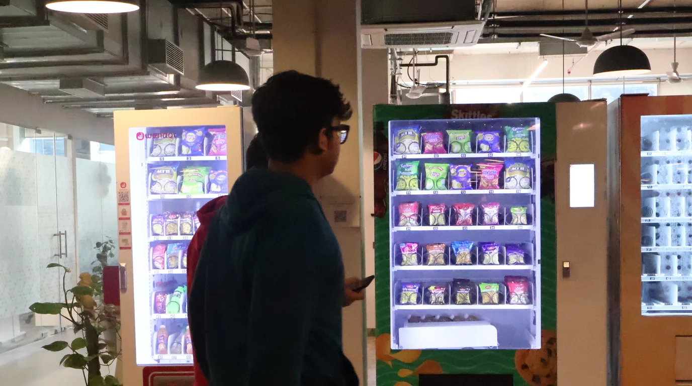 Overhead flat-lay with a Texas sales-tax permit, calculator, and vending machine model