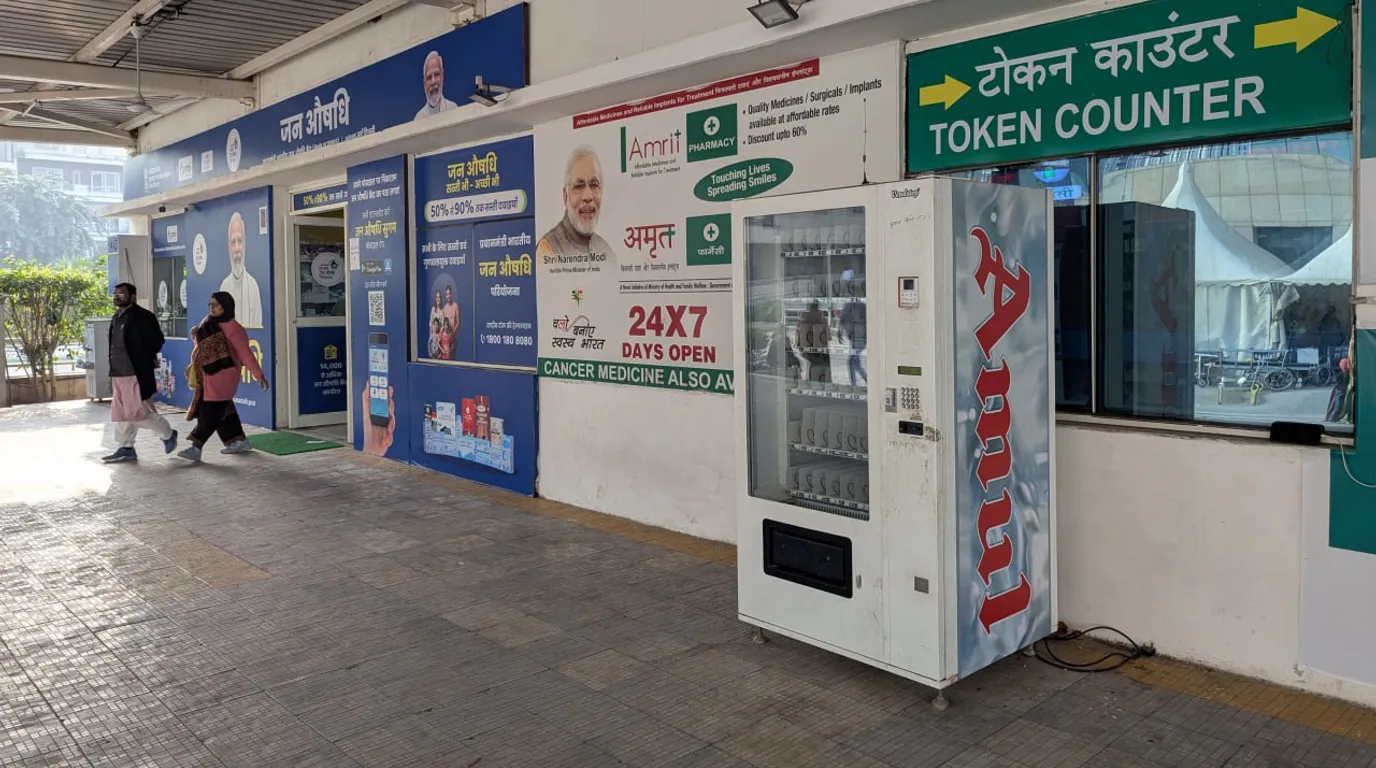 New vending machine being set up with protective film and branding panel nearby