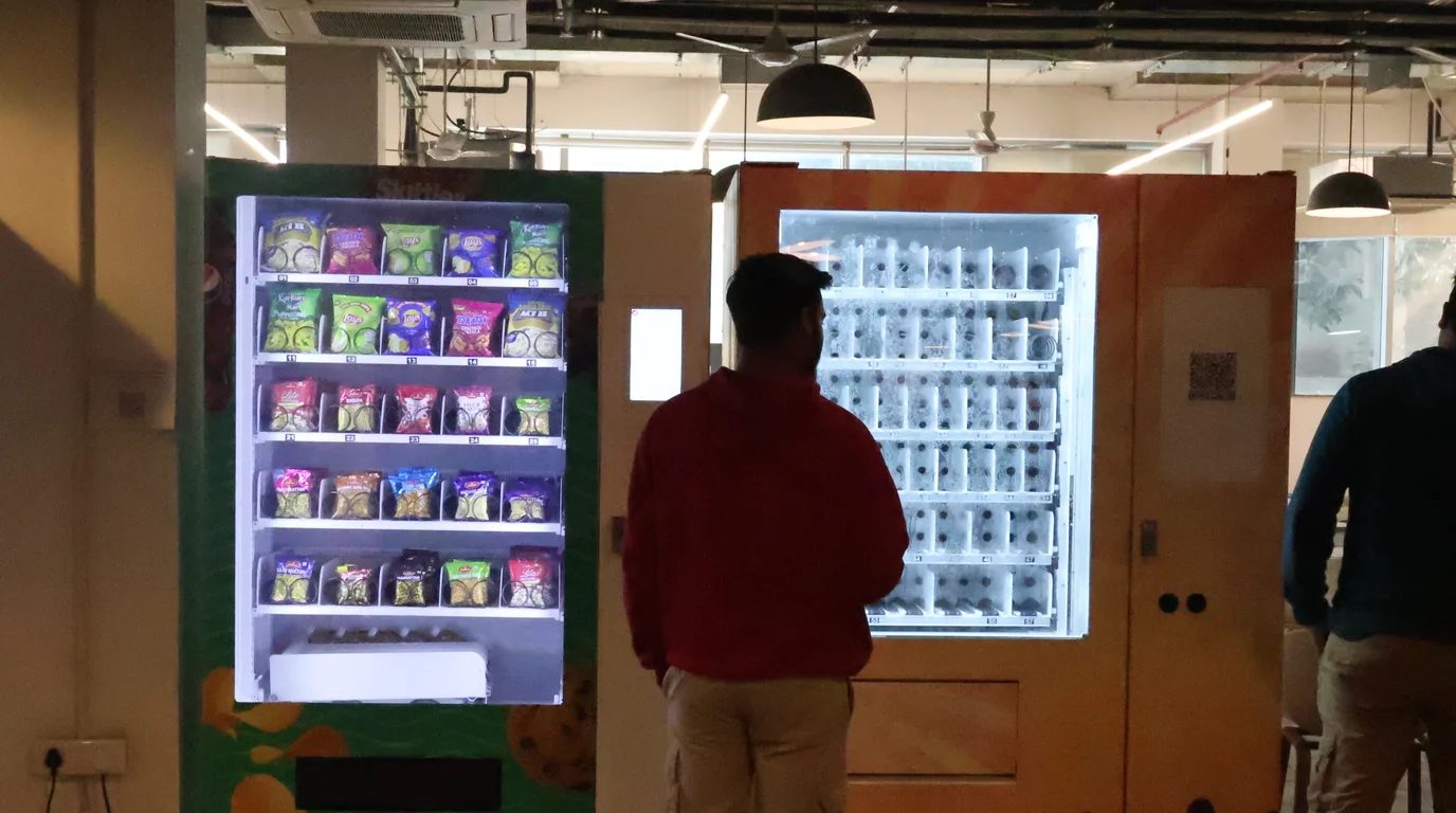 Cutaway view of a vending machine showing layered internal component zones