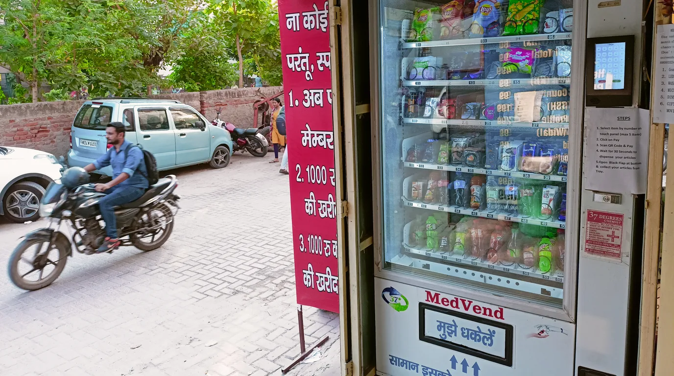 Independent operator setting up their first vending machine in a bright lobby
