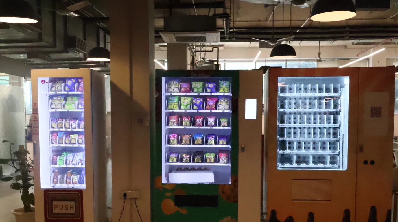 Overhead desk with a blank reference grid and small vending machine icons