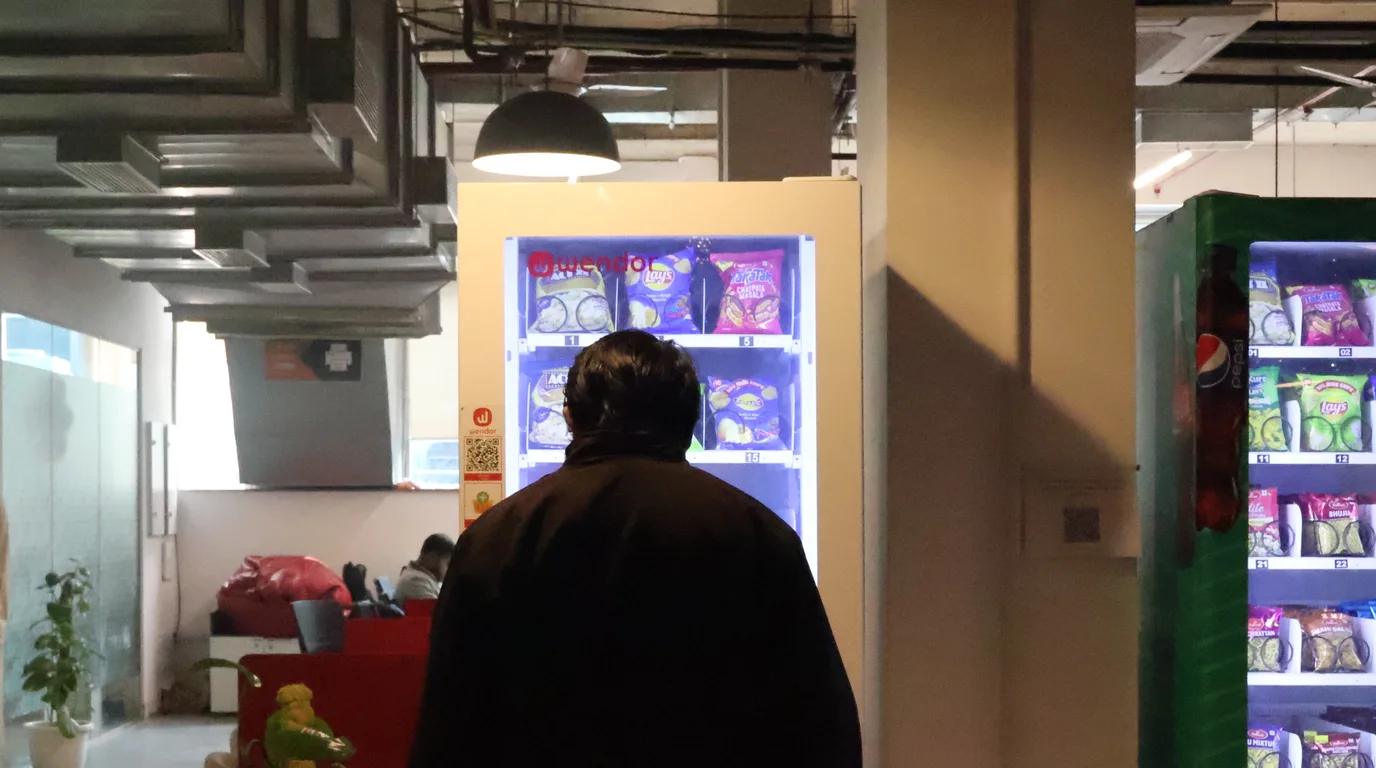 Relaxed entrepreneur viewing a remote vending sales dashboard at a cafe