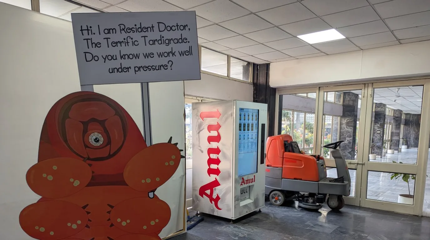 Operator doing a morning check on a vending machine in a sunlit lobby