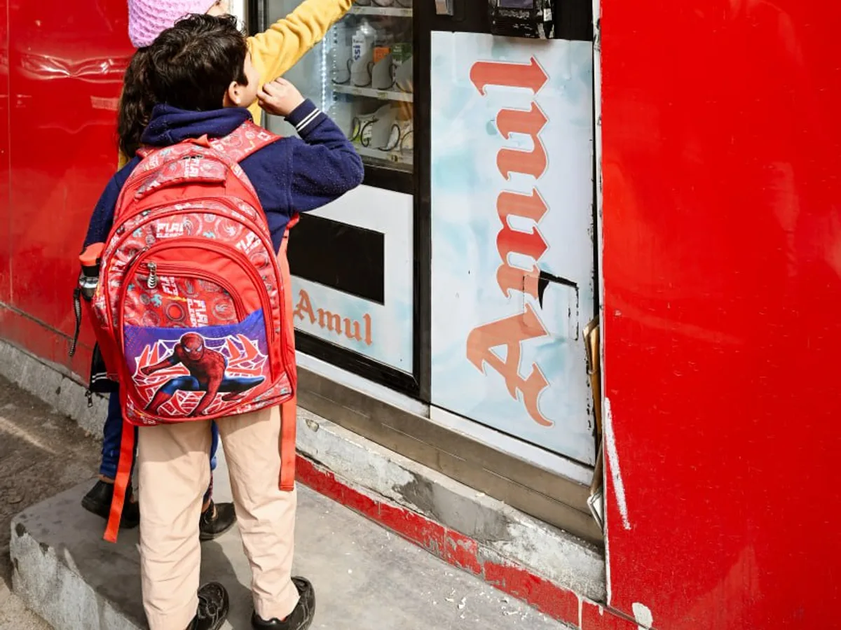 Technician installing a vending machine as an operator checks a service agreement