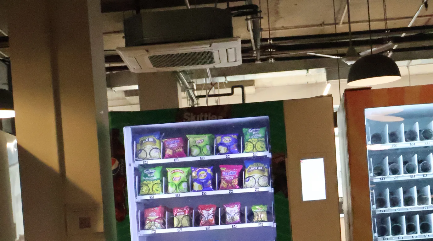 Flat-lay grid of vending machine components on a clean workbench