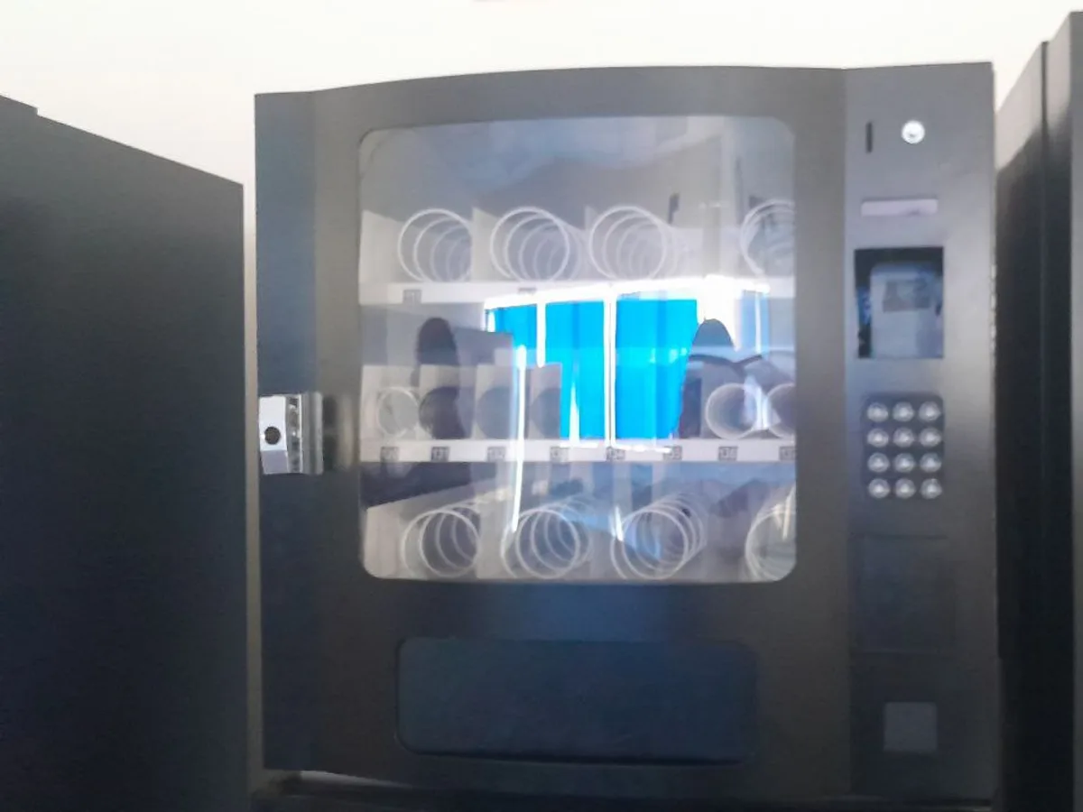 Buyer doing due diligence research at a desk near a vending machine model