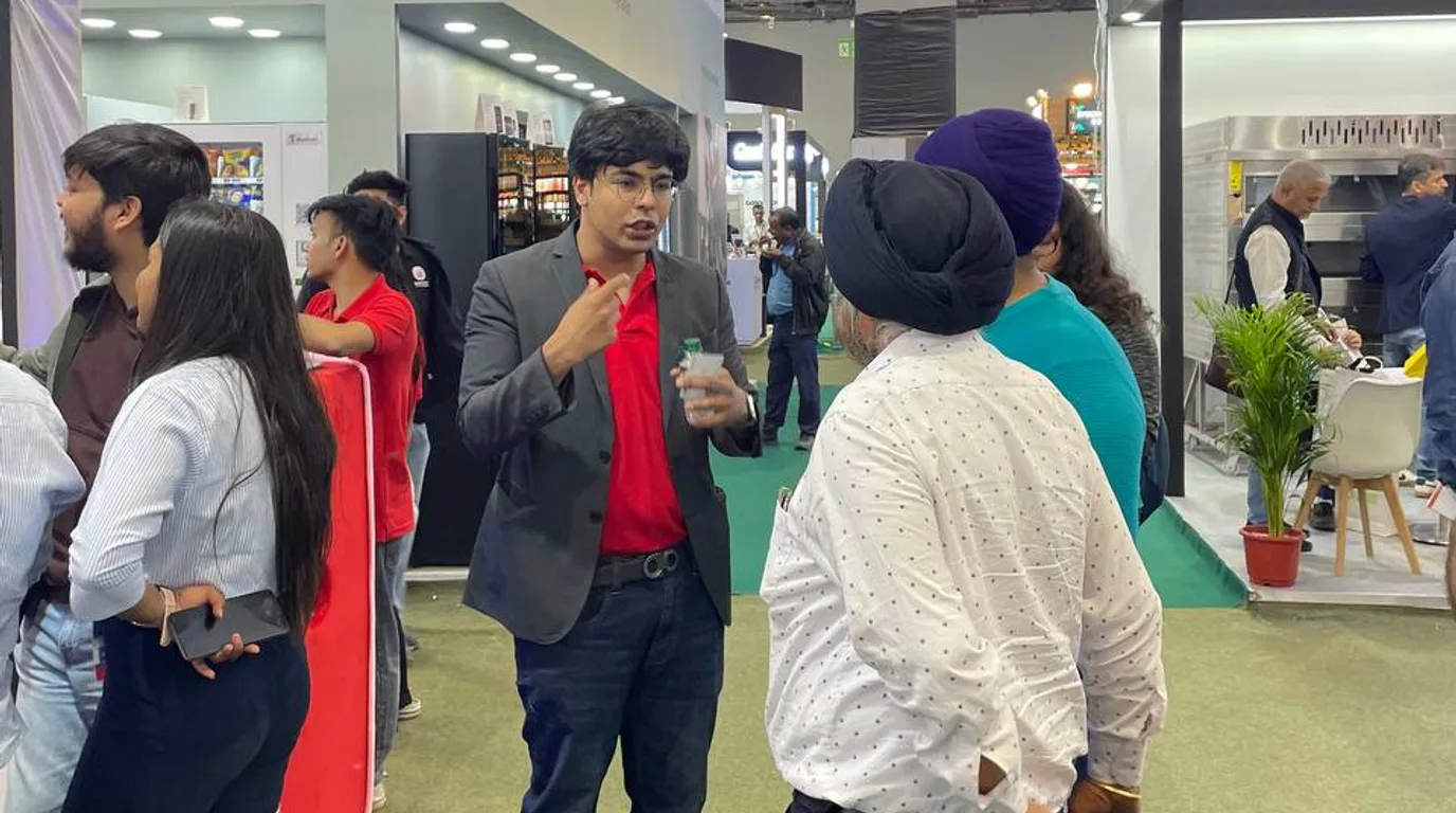 Young people using a modern vending machine with UPI payment on a campus